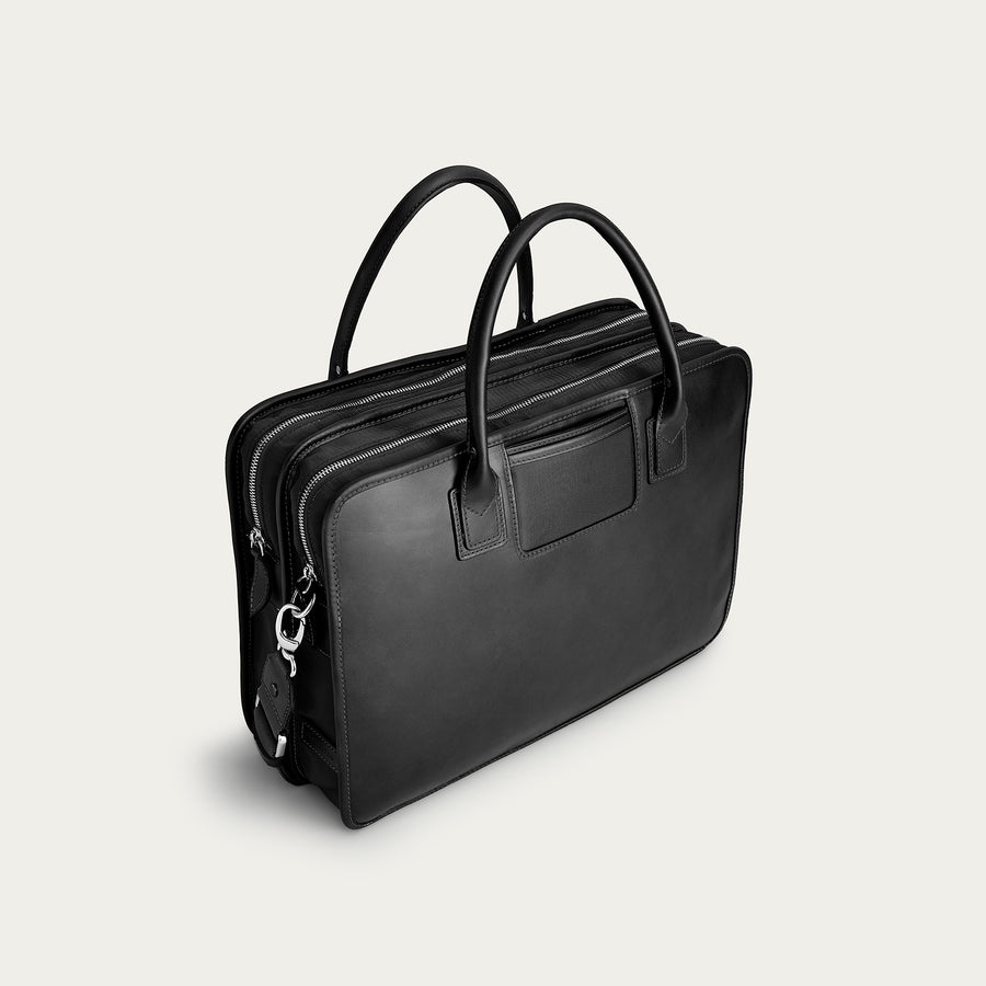 Black leather briefcase on a light gray background